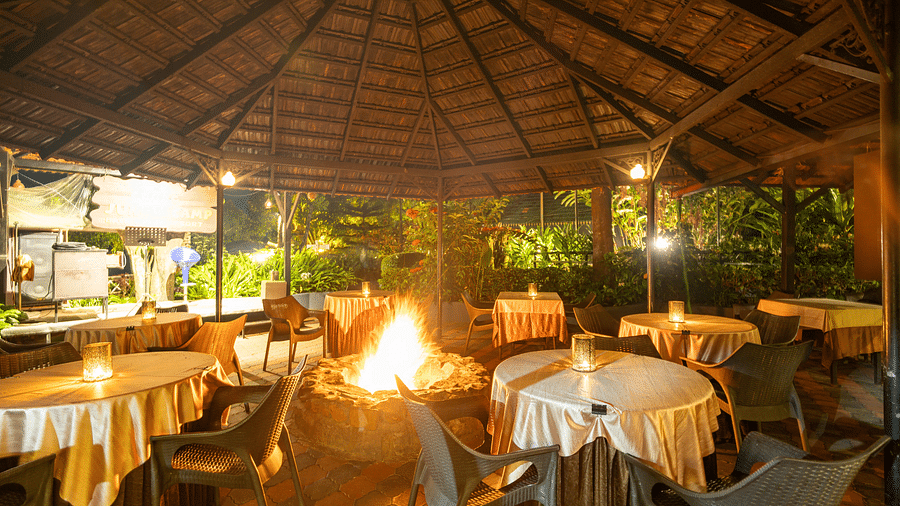 Image of a dining space with a bonfire in the middle at Coorg Jungle Camp.