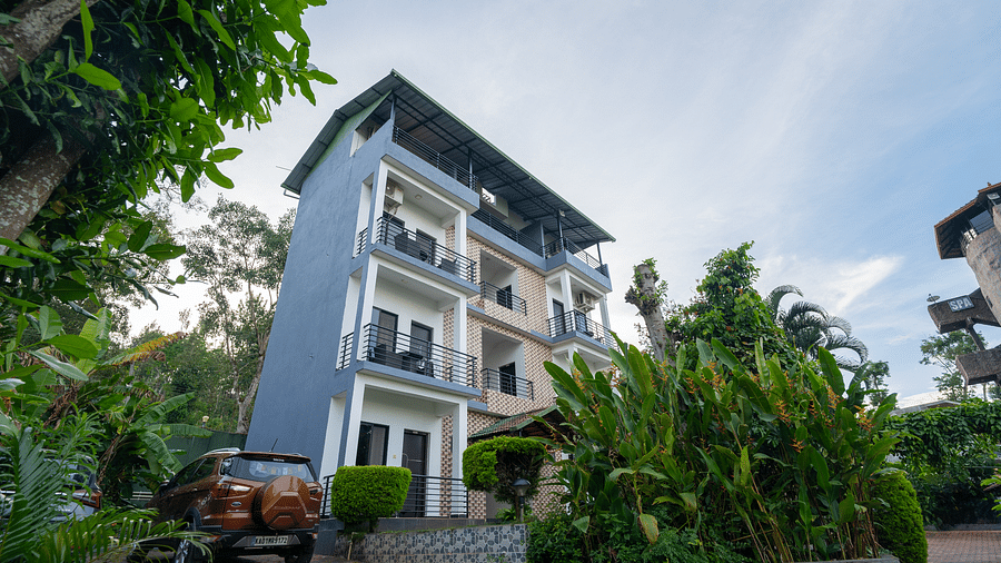 Facade of an accommodation surrounded by plants at Coorg Jungle Camp.
