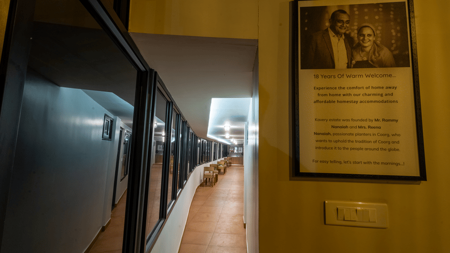 Indoor resort corridor featuring framed wall art, soft warm lighting, and neutral decor.