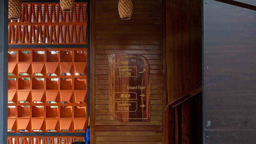 A close-up view of intricately arranged wooden panels on a building facade. The natural wood finish complements the rustic charm of the space, with soft lighting adding warmth - Coral Reef Resort & Spa, Havelock