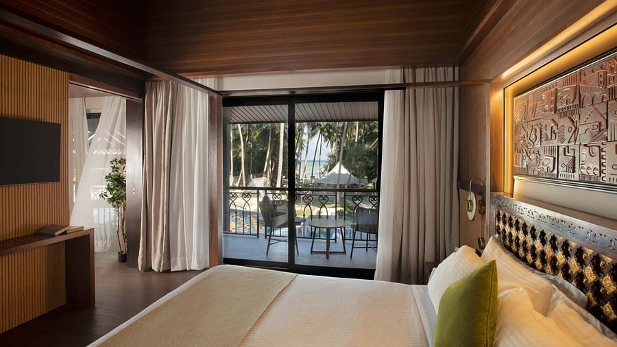 Image of the doorway to the balcony taken from the plush bed in Coral Teal Suite at Coral Reef Resort and Spa in Havelock