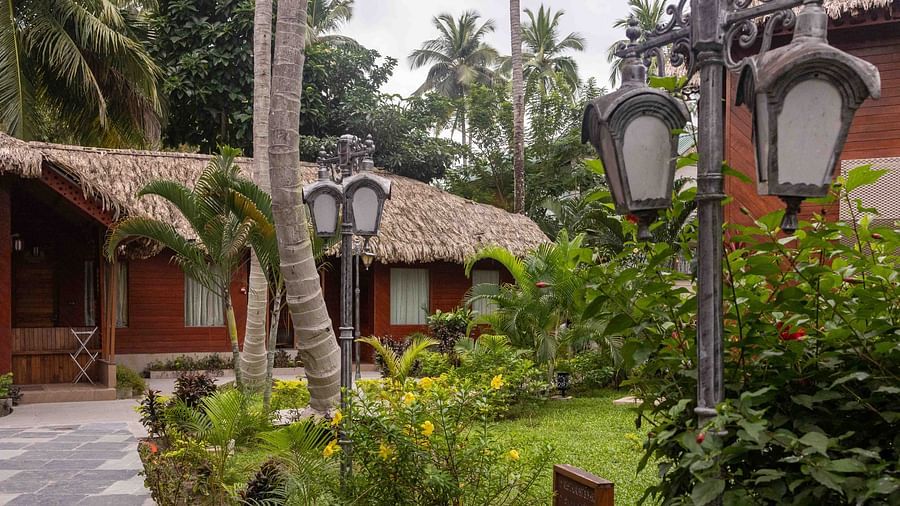 Image of the facade of Coral Azure at Coral Reef Resort and Spa in Havelock featuring cosy huts with bricked pavements and small gardens on the sides