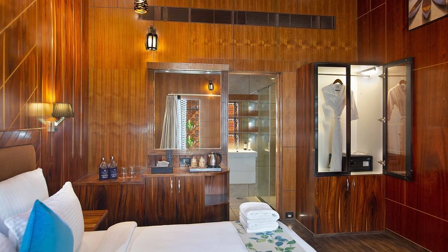 Image of Coral Azure at Coral Reef Resort and Spa in Havelock featuring a double bed with bath towels on it and a mirror next to the bed with tea and coffee maker under it on the desk 