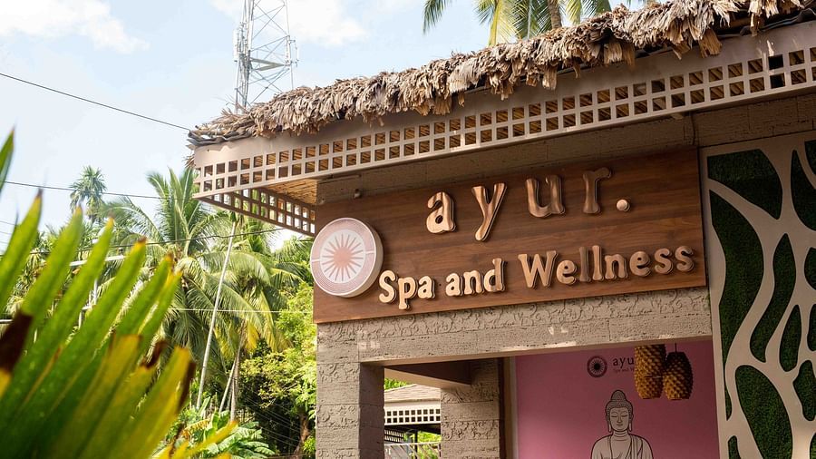 A sign for the Ayur Spa and Wellness centre at Coral Reef Hotel & Spa in Havelock with an elegant design featuring a calm, relaxing atmosphere. The surrounding greenery adds to the peaceful setting - Coral Reef Resort & Spa, Havelock