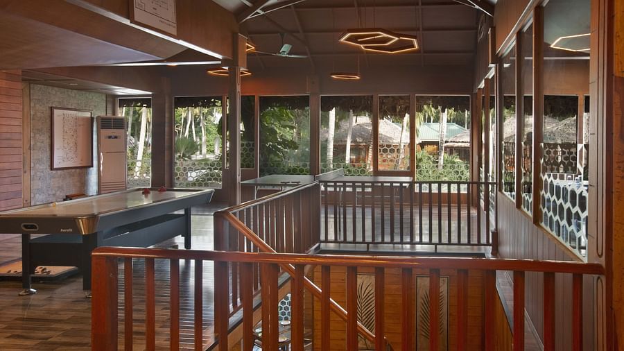 A well-designed interior with a staircase and elegant wooden railings. The natural light streaming through the windows adds to the open and airy feeling of the space - Coral Reef Resort & Spa, Havelock