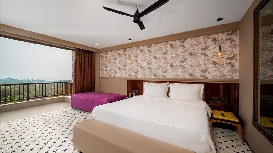 An image showcasing a spacious bedroom with elegant interiors and modern amenities at Crescent Resort, Goa