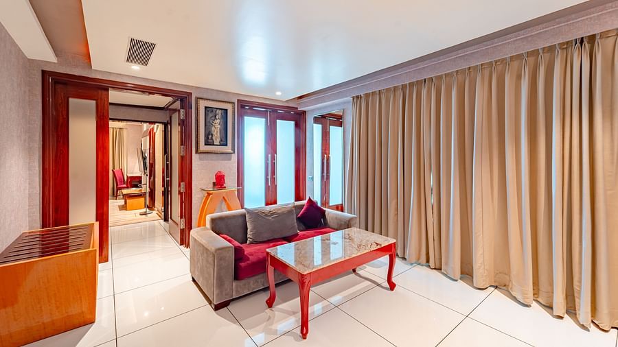 Executive Suite features a large sofa with a table in front at Crescent Spa & Resort, Indore.