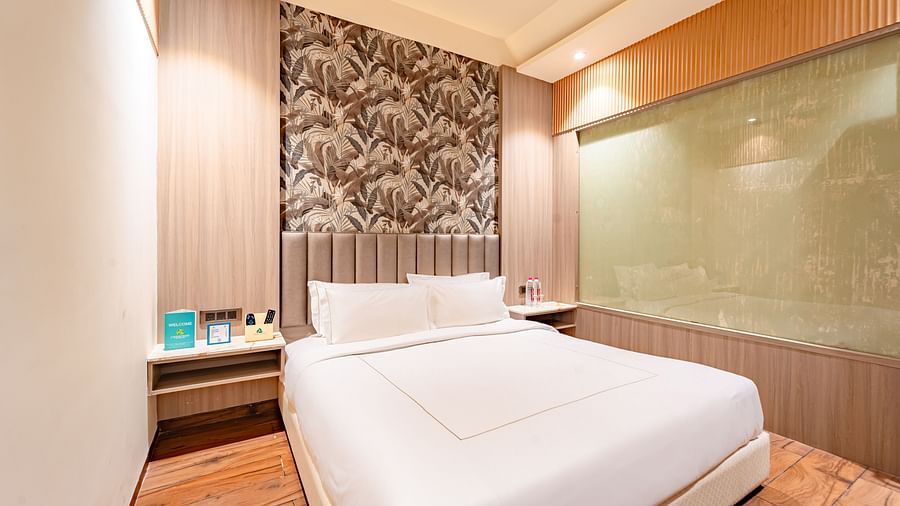 Family Room features a spacious bed, two bedside tables, and warming lighting at Crescent Spa & Resort, Indore