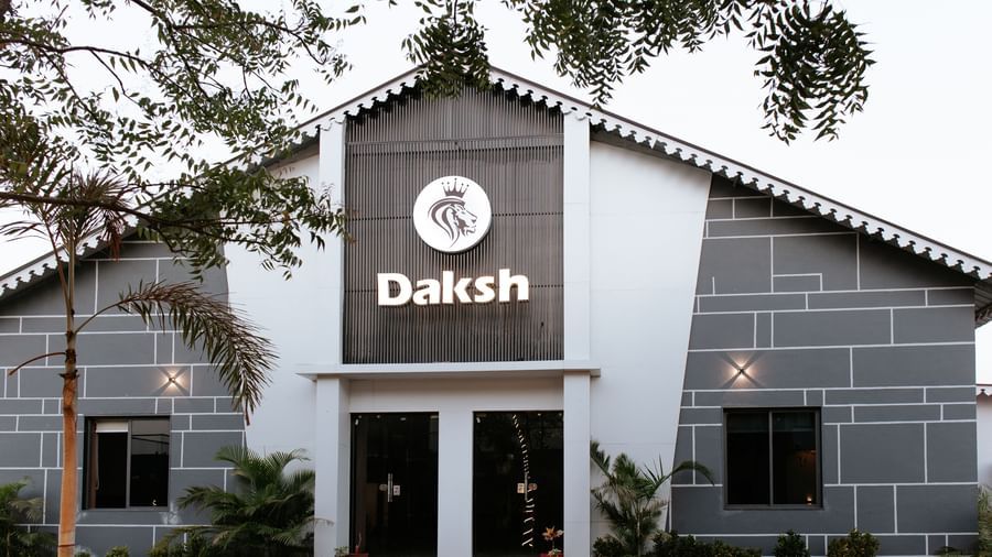 Shot of the facade of Daksh Eden Greenz in Sasan Gir with trees in the front.
