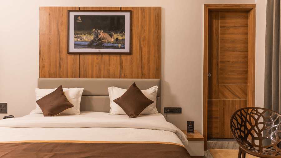Close up of a plush double bed in the Daksh Comfort room at Daksh Eden Greenz, Sasan Gir.