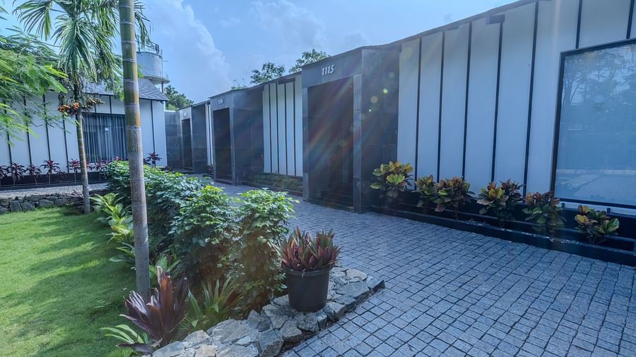 image featuring a pathway in front of the garden rooms with a lush green lawn besides it - Darza Resorts
