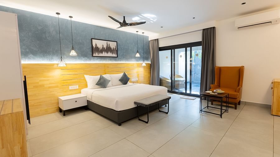 full view image of the expansive garden room featuring a king size bed in the middle of the room - Darza Resorts