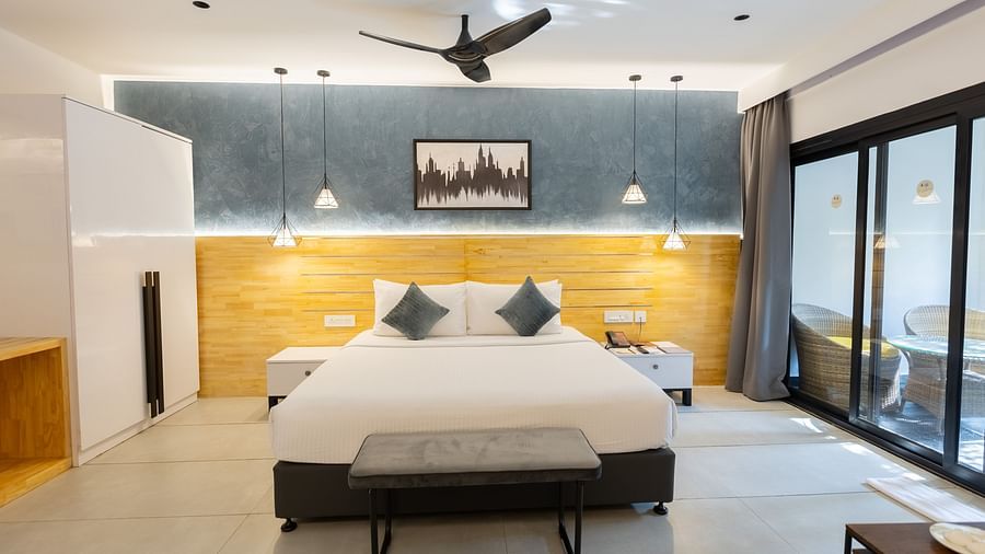 front view image of the double bed with a ceiling fan above it - Darza Resorts