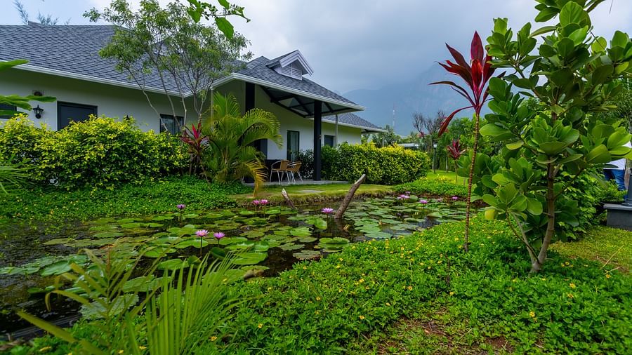 exterior image of the luxury group stay villa with a pond in front of it - Darza Resorts