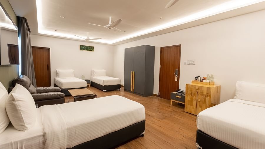 image of a bedroom with four single beds along with a wardrobe in the luxury group stay villa - Darza Resorts