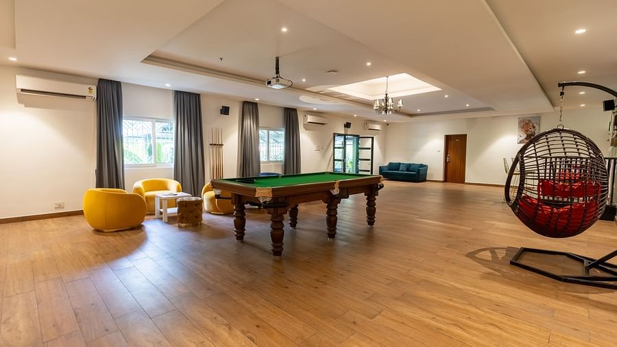 corner view image of the living area of the luxury group stay villa featuring indoor games and a swing - Darza Resorts
