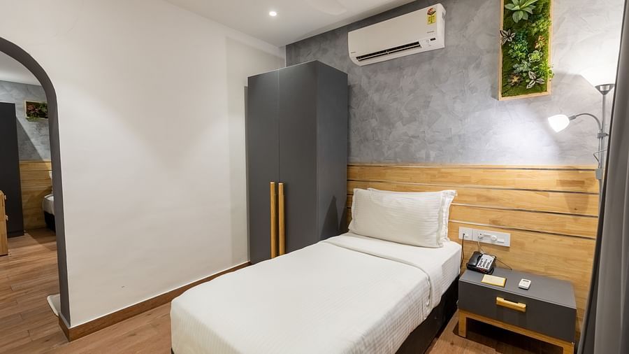 image featuring a single bed with a small wardrobe and a bedside table in a room of the luxury group stay villa - Darza Resorts
