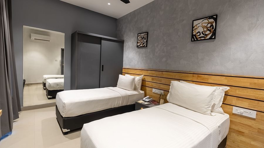 image of a bedroom at the luxury group stay villa featuring a twin bed with a full length mirror - Darza Resorts