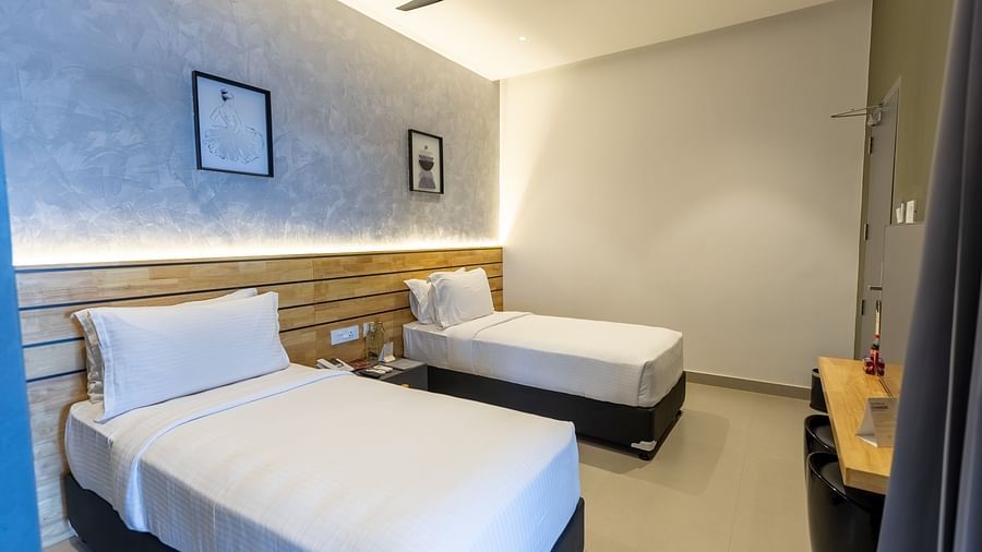corner view image of a bedroom with twin beds at the luxury group stay villa - Darza Resorts