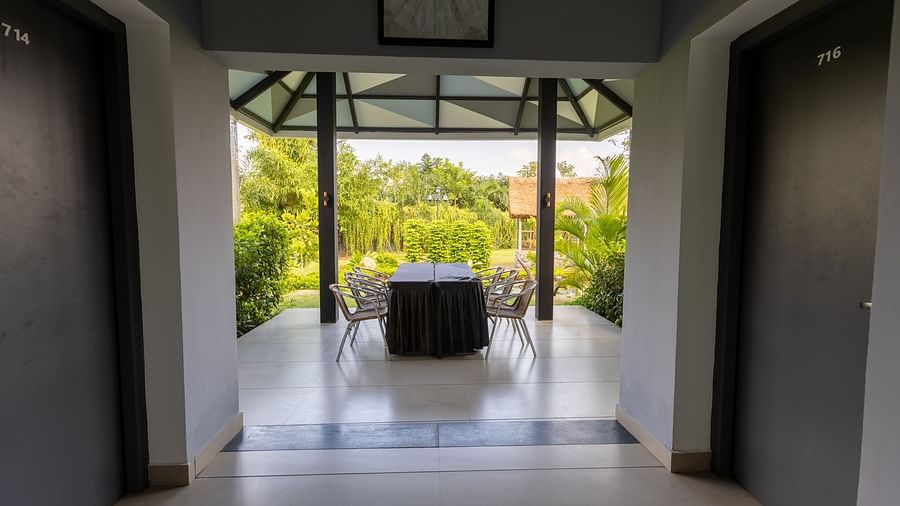 image of the outdoor dining area overlooking the lush green surrounding from the porch of the luxury group stay vill - Darza Resorts