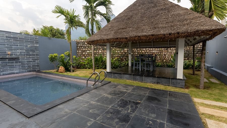 exterior facade image of the luxury villa with a hut area besides the swimming pool - Darza Resorts