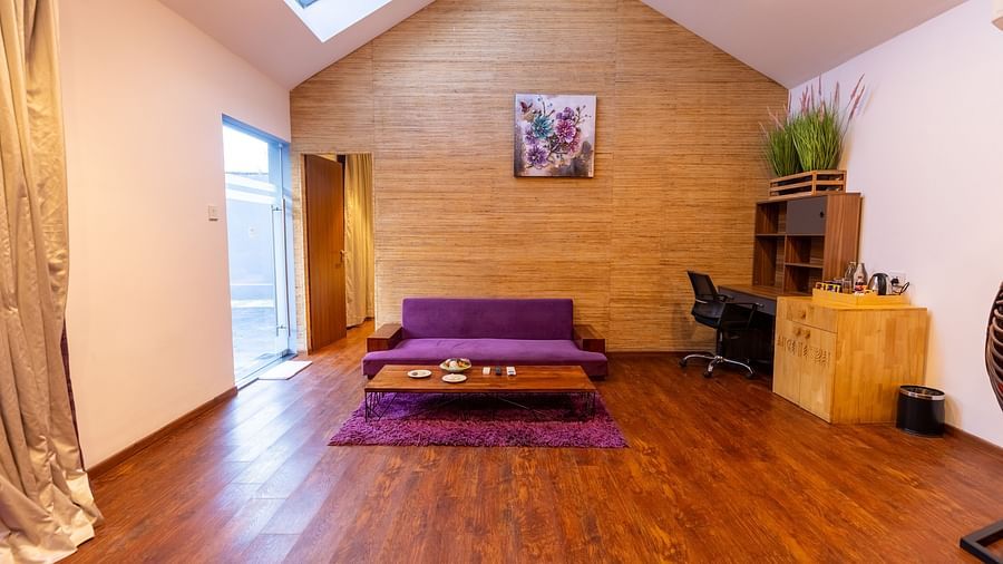 image of the living room with a purple coloured couch at the luxury villa - Darza Resorts