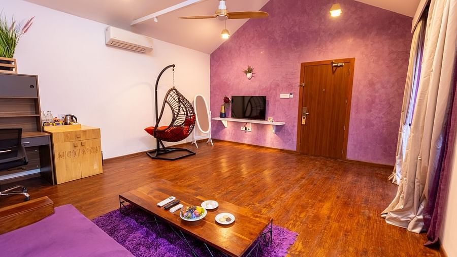 full view image of the living room at the luxury villa with a coffee table in front of the couch and a wall mounted tv - Darza Resorts