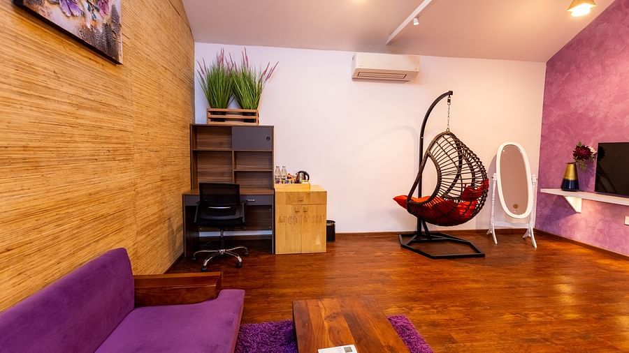 side view image of the luxury villa featuring a work desk besides a wooden cabinet - Darza Resorts