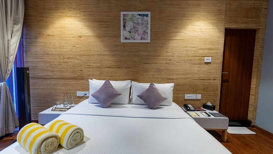 front view image of the king size bed at the luxury villa with bed side tables besides it - Darza Resorts