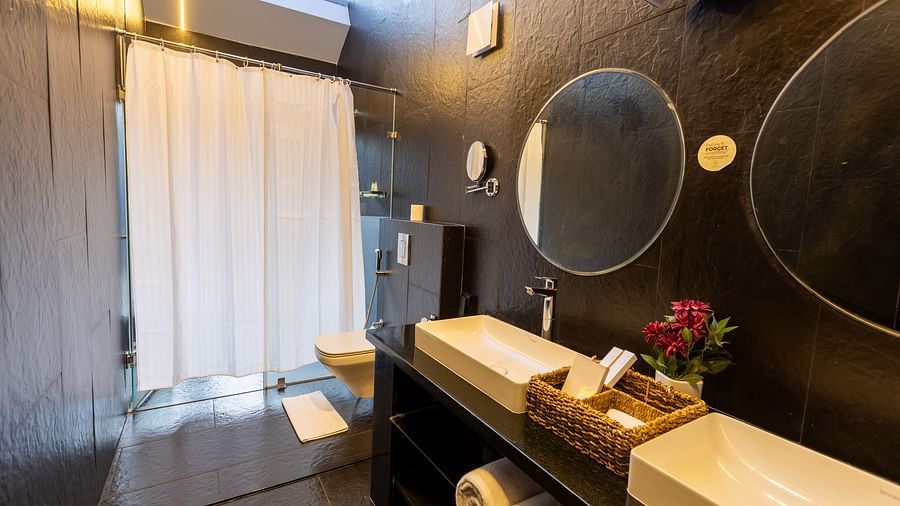 image of a modern bathroom with two washbasins and circular mirrors at the luxury villa - Darza Resorts