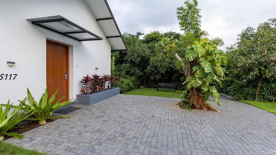 exterior facade image of the luxury villa with a stone pathways nestled amidst lush greenery - Darza Resorts