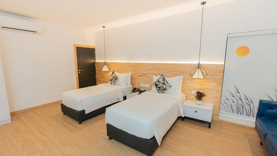 image of the garden room featuring two twin beds with bed side tables besides them - Darza Resorts