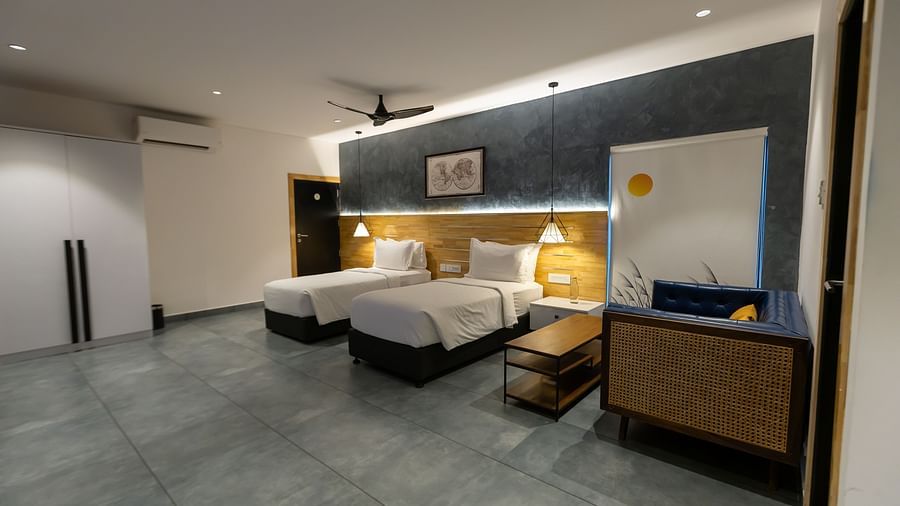 image of a spacious bedroom featuring two twin beds with modern interiors