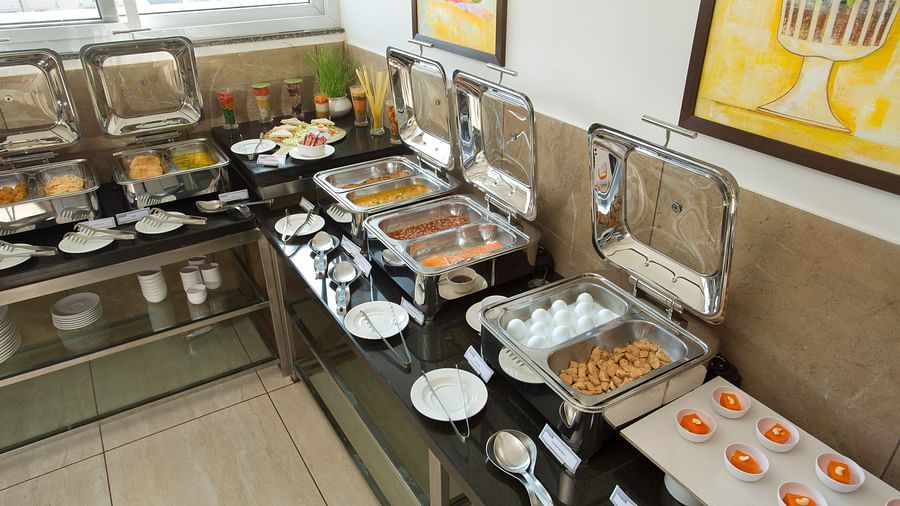 A hotel buffet station featuring a variety of hot dishes - De Venetian by TGI, Brookefield
