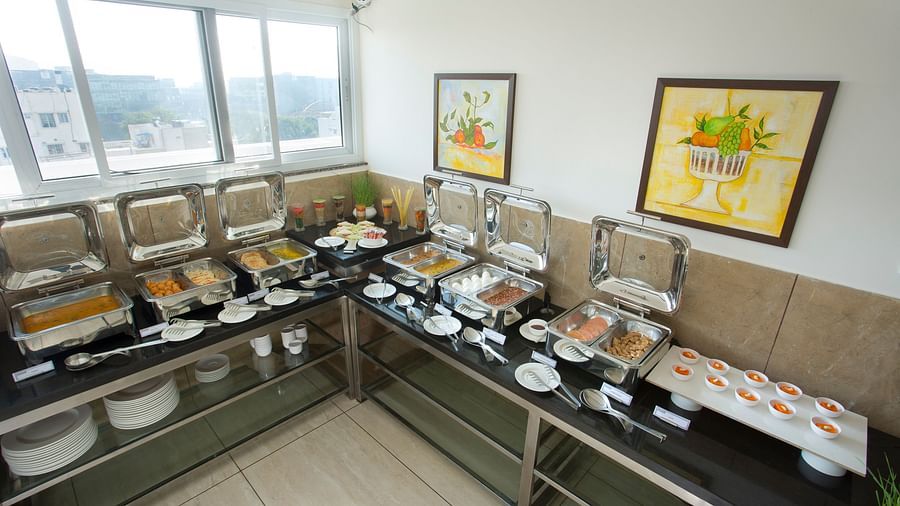 Another view of a hotel buffet station featuring a variety of hot dishes - De Venetian by TGI, Brookefield