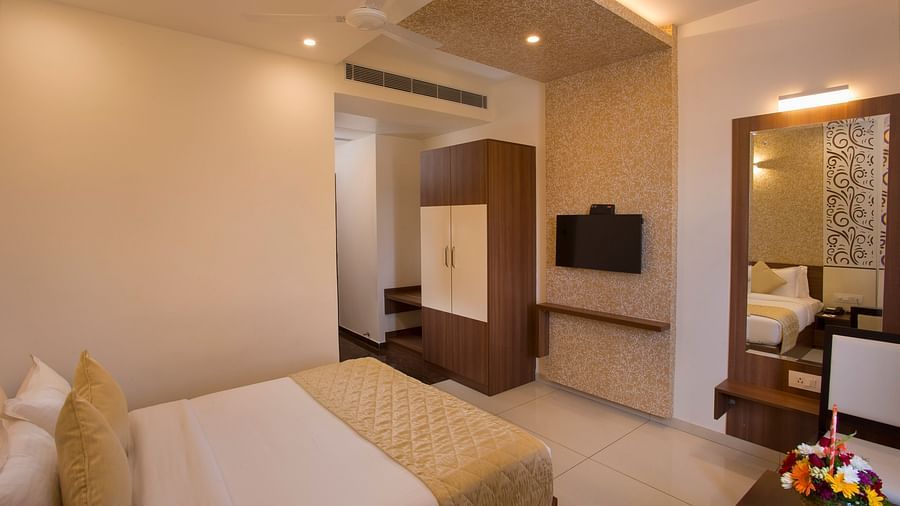 A cosy hotel bedroom with a large bed, decorative wallpaper and a giant mirror - De Venetian by TGI, Brookefield