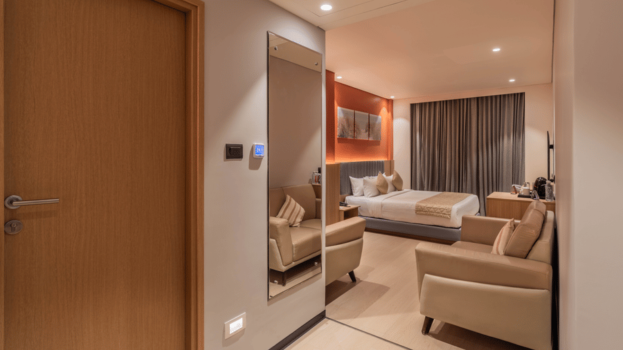 Elegant Suite Room at De Venetian by TGI with a comfortable lounge area and contemporary furnishings.