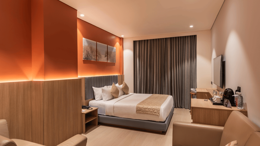 Contemporary Suite Room at De Venetian by TGI with warm lighting, elegant furnishings, and a relaxing ambiance.