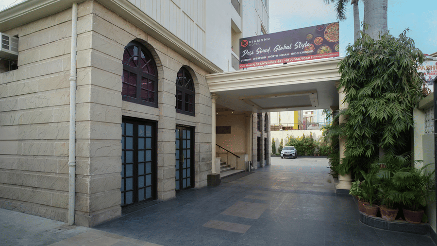 The stone-clad exterior and driveway of Diamond Hotel Varanasi offer a clean and welcoming entrance for guests.