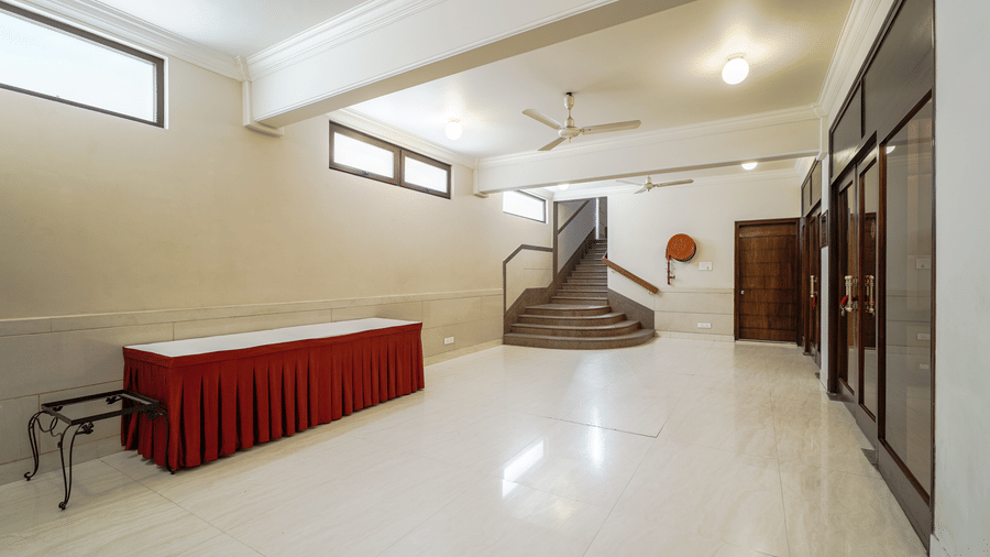 A neat buffet or service counter stands in a wide hall at Diamond Hotel Varanasi.