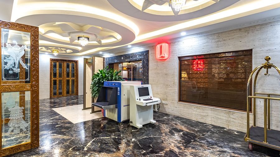 Elegantly designed lobby at Diamond Palace Lords Plaza with marble flooring, ornate ceiling, and security equipment.