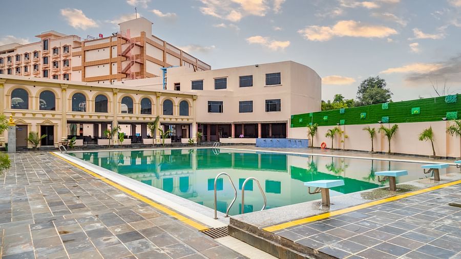 Outdoor swimming pool with a building in the background