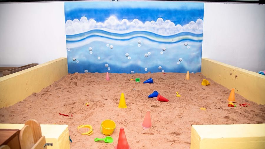 Indoor sandbox play area for children with beach-themed mural | Diamond Parks, Pune