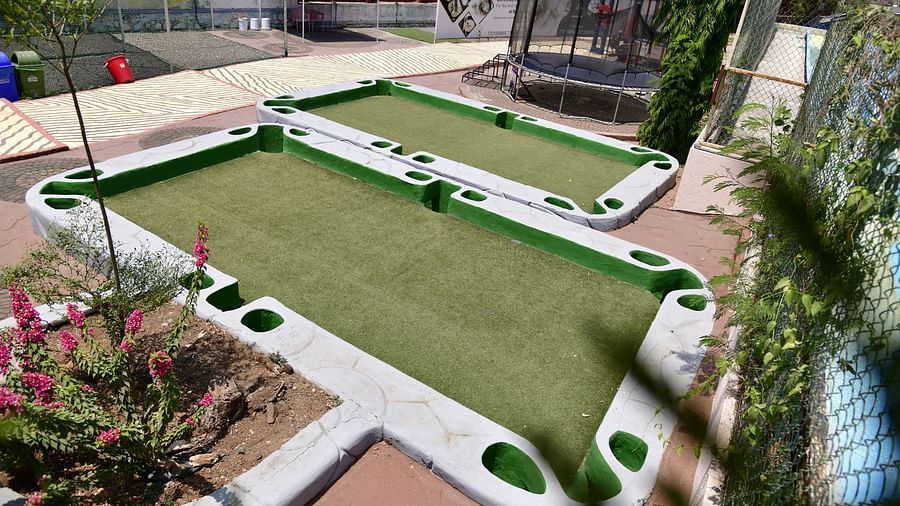 Outdoor mini golf course with green playing surfaces and white barriers | Diamond Parks, Pune
