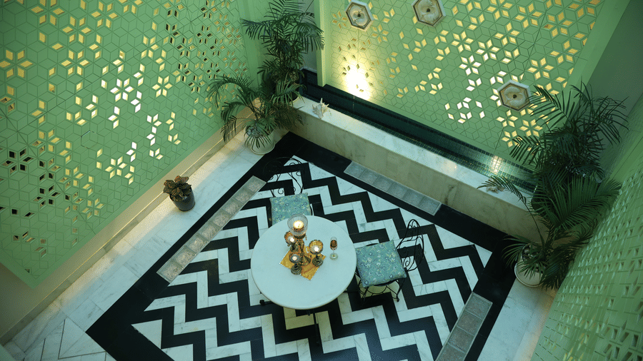 Elegant dining interior at Dileep Kothi, Jaipur with artistic wallpaper and stylish decor details.