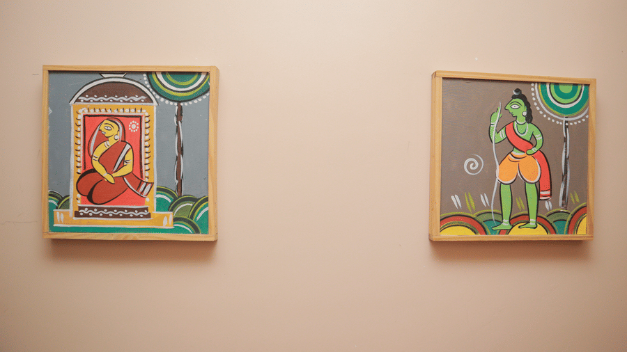 2 framed paintings hung on a wall featuring illustrations of a woman and a man in traditional attire at Dip Holidays.