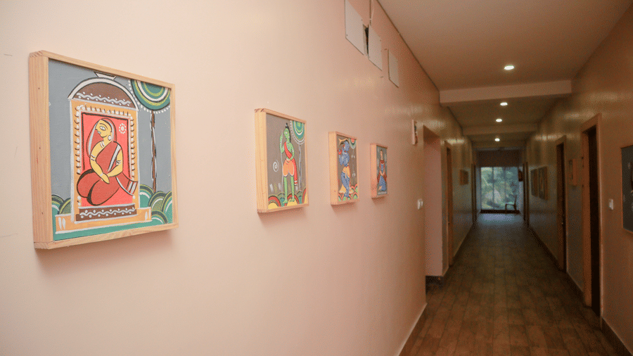 The lobby of Dip Holidays with paintings hung on the wall at equal distances.