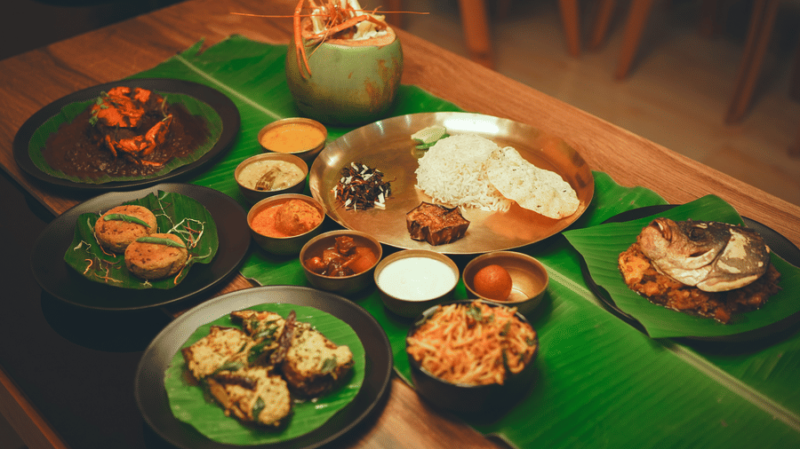 A bengali meal platter along with several bengali delicacies served on banana leaves at Dip Holidays.