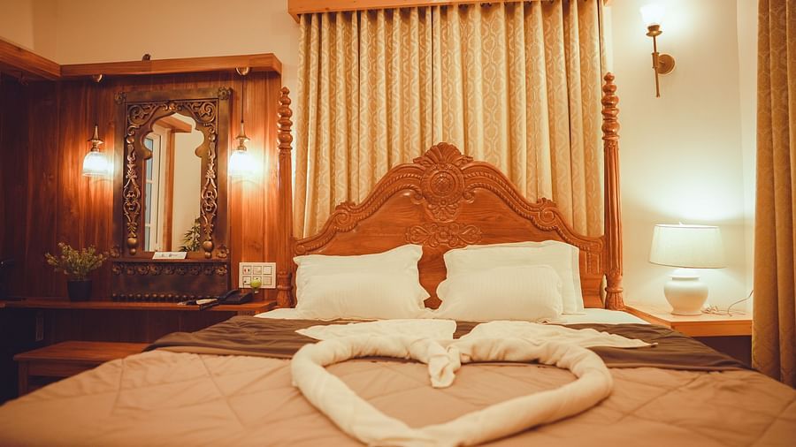 front view image featuring a plush king size bed with towel decorations over the bed