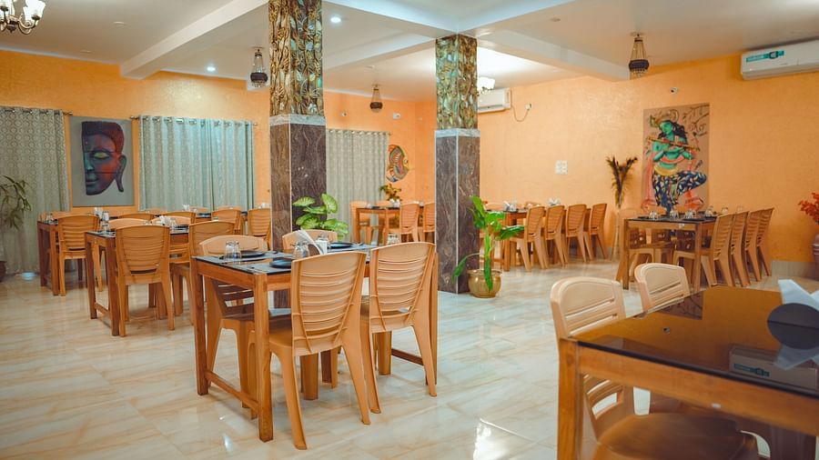 image of a well lit dining area with proper seating arrangements for the guests - Dip Holidays, Birbhum